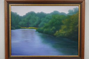 Framed painting of a river surrounded by green trees