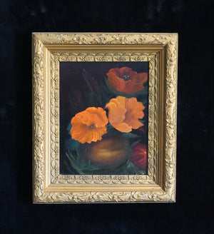 A framed still life painting featuring vibrant orange and red poppies in a dark vase, enclosed in an ornate gold frame and displayed against a dark textured background.