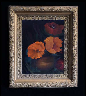 A framed still life painting featuring vibrant orange and red flowers in a dark vase against a dark background, enclosed in an ornate gold-toned frame.