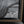 Close-up of a framed black and white painting with a visible signature reading 'Becki Korthuis' in white script, set in a dark frame with a gold-toned beaded inner border.