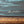 Close-up of the signature appearing to read Knox, with teal wave brushwork, visible canvas texture, and gold-toned frame trim.”