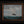 Where Courage Sails painting of a white-sailed ship on teal waves beneath cloudy skies, in a dark frame with gold trim.”