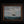 Wider view of Where Courage Sails in its decorative dark frame, with white sails, seabirds, and a cloud-filled sky.”