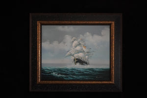 Wider view of Where Courage Sails in its decorative dark frame, with white sails, seabirds, and a cloud-filled sky.”