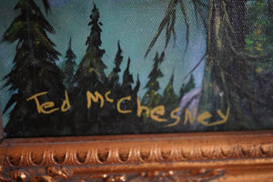 Close-up of Ted McChesney’s painted signature, canvas texture, and the ornate frame on A World Worth Thanking.”⠋

