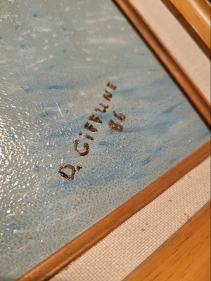 Close-up of a signature on a textured surface with a wooden frame.