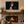 The Crown of the Wild 24 × 16 inch canvas displayed above a stone fireplace in a living room