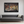 Where Fire Walks 36x24 - Black frame above sofa